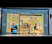 Storefront of Magrabi featuring a modern design, showcasing eyewear displays and a large advertisement for sunglasses