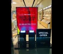 A retail display featuring a bright red sign advertising a mid-year special offer on selected items, with illuminated stands